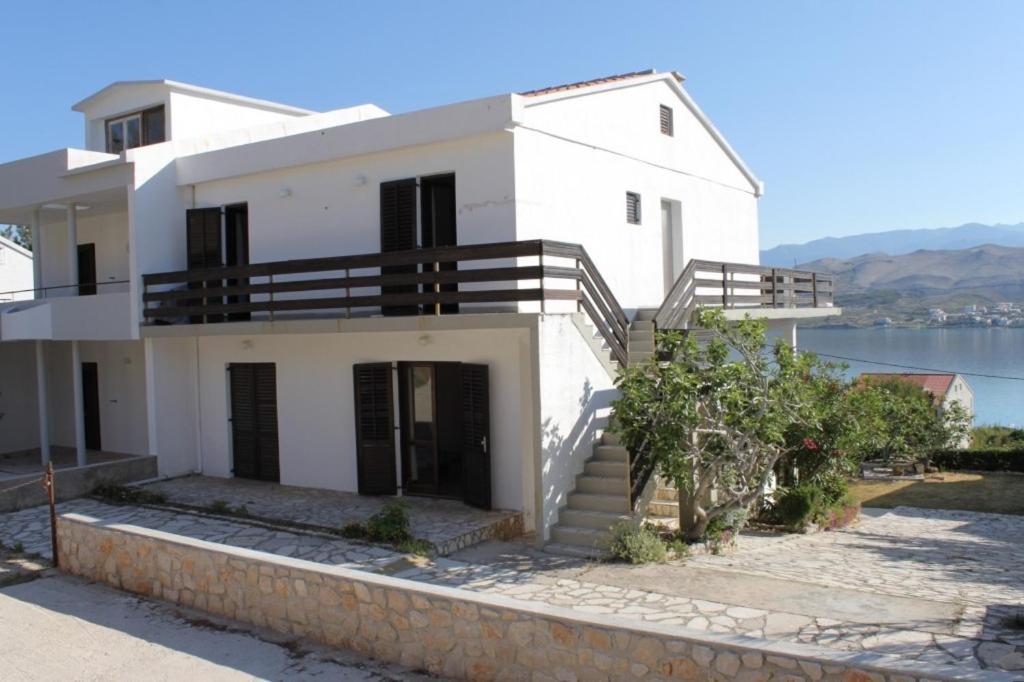 a white house with a view of the water at Apartments with a parking space Pag - 6529 in Pag