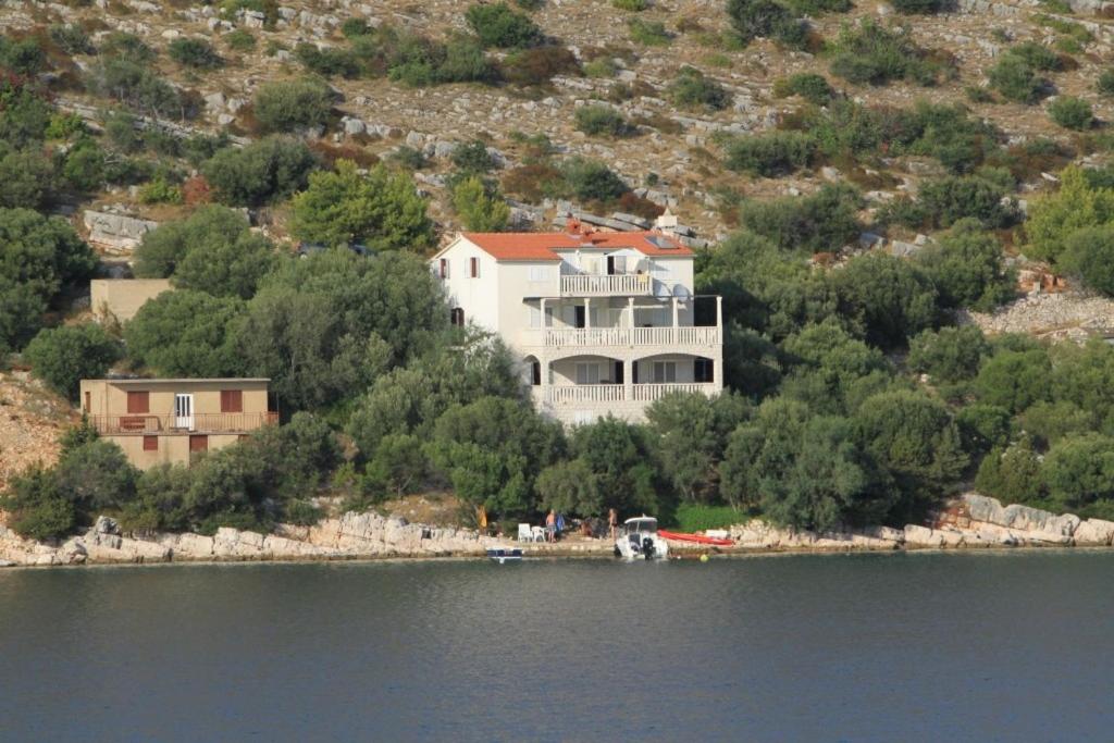 a large house on the shore of a lake at Apartments by the sea Skrivena Luka, Lastovo - 8352 in Lastovo