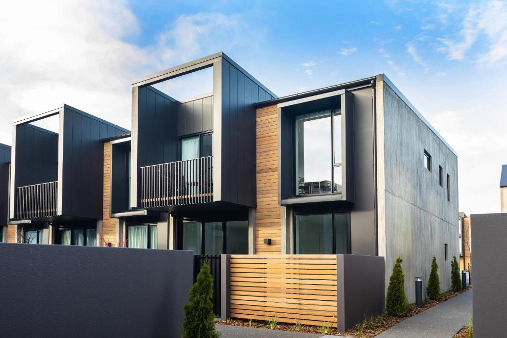 a modern house with black and wood exterior at URBAN RETREAT in Christchurch