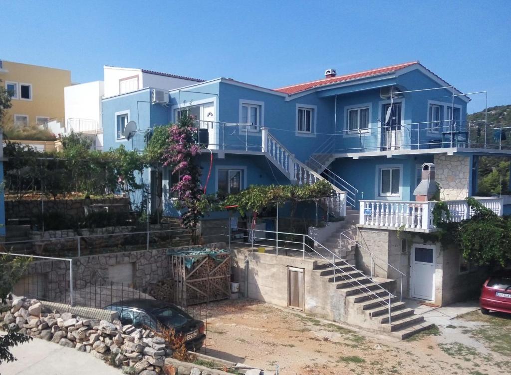 a blue house with stairs in front of it at Apartments with a parking space Sali, Dugi otok - 8181 in Sali