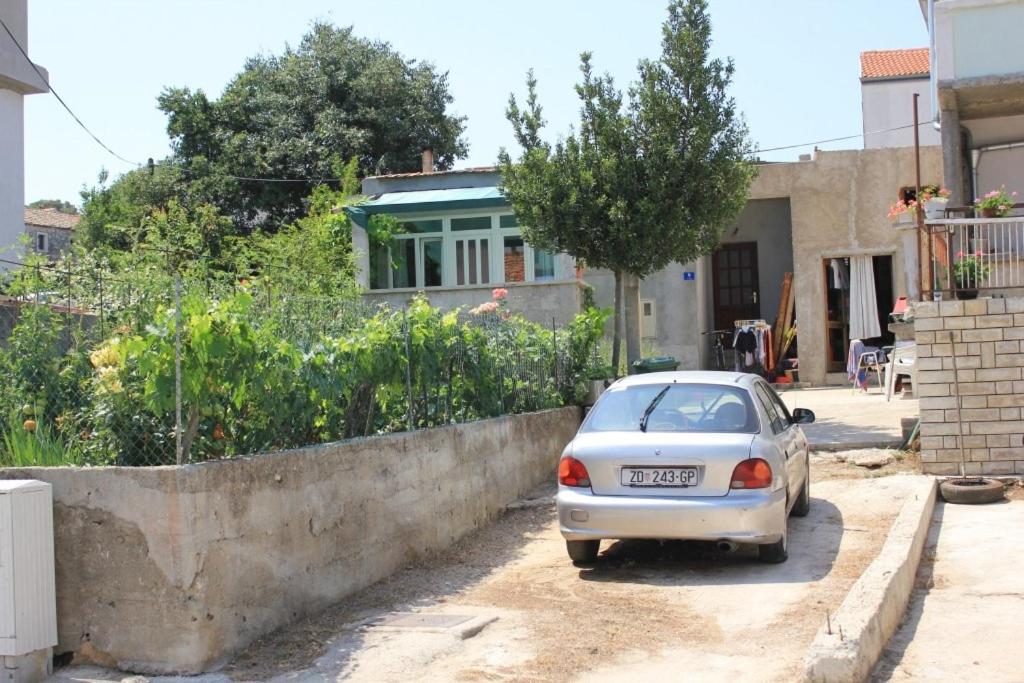 a small car parked in front of a house at Apartments by the sea Tkon, Pasman - 8303 in Tkon