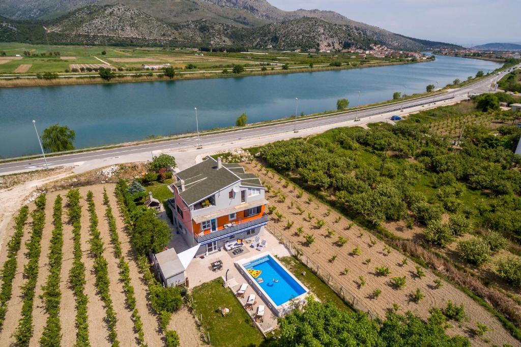 an aerial view of a house next to a river at Holiday house with a swimming pool Opuzen, Neretva Delta - Usce Neretve - 8818 in Opuzen