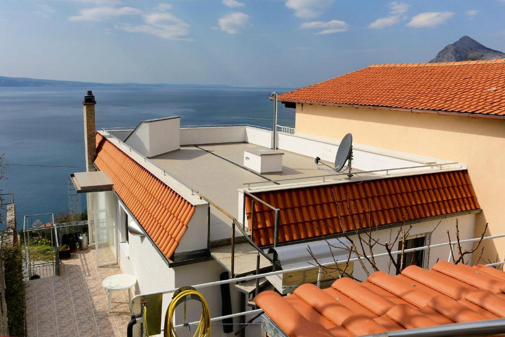 a view of a building with a view of the water at Apartments with a parking space Omis - 10349 in Omiš