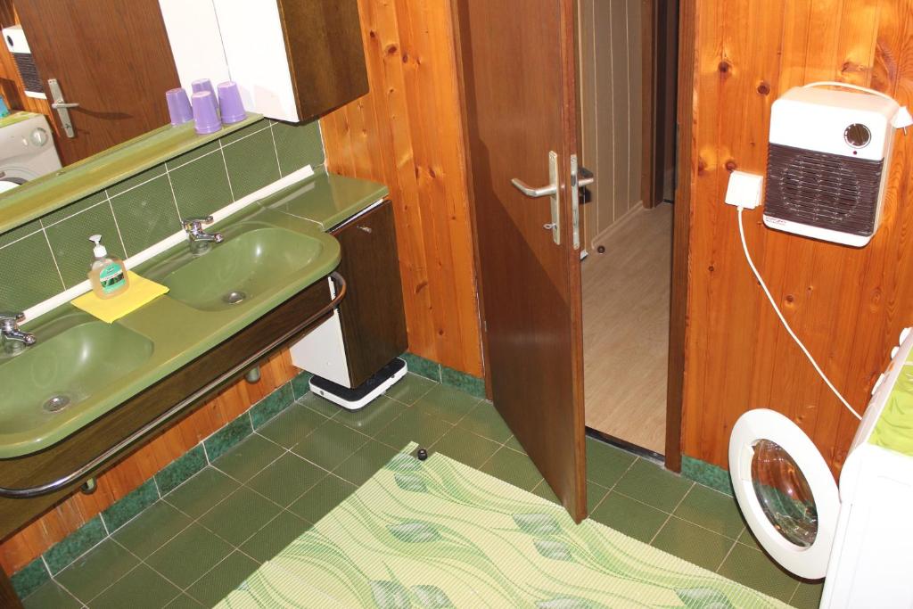 a bathroom with a sink and a phone on the wall at Apartments with a parking space Liznjan, Medulin - 11152 in Ližnjan