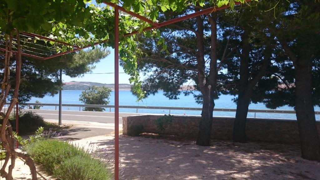 a view of the water from a park with trees at Apartment Seline 11197b in Starigrad