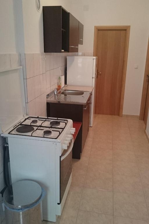 a small kitchen with a stove and a refrigerator at Apartment Seline 11197b in Starigrad