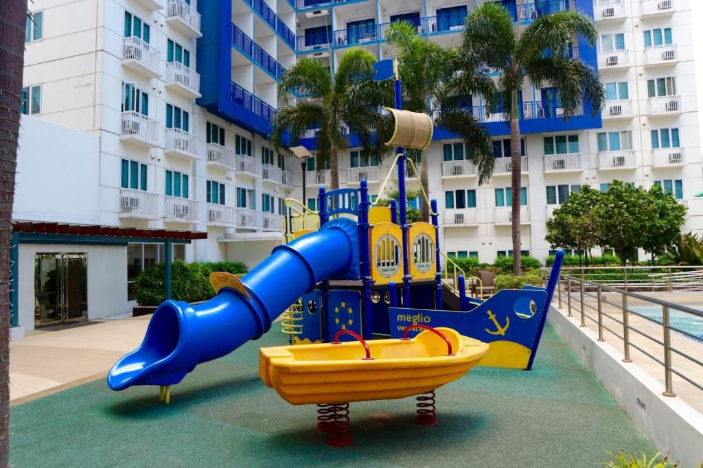 a playground in front of a building with a slide at Sea Residences - Property Val Alano 0995-448-8872 in Manila