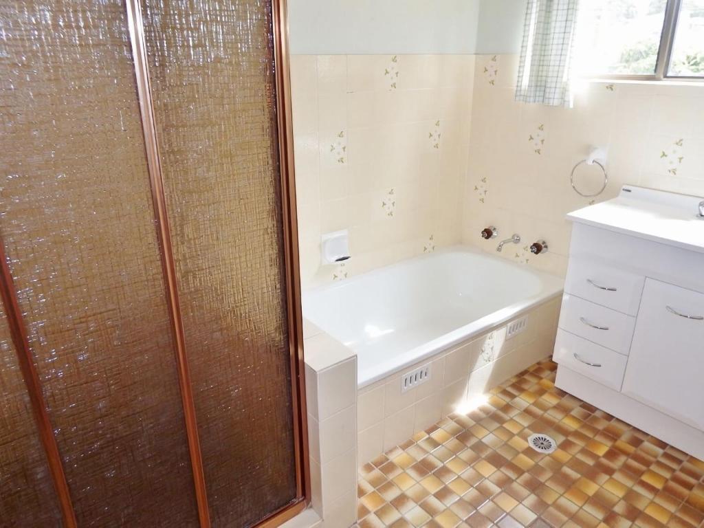 a bathroom with a shower and a tub and a sink at Woody Wonder Unit 2 South West Rocks in South West Rocks