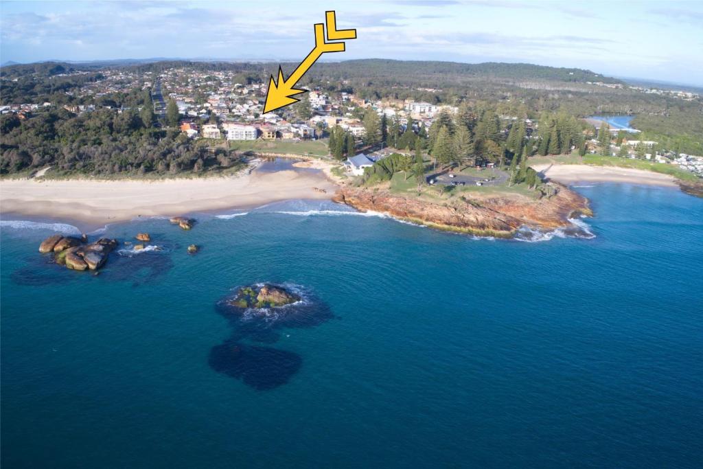an aerial view of an island in the ocean at Anglers Lodge 4 in South West Rocks