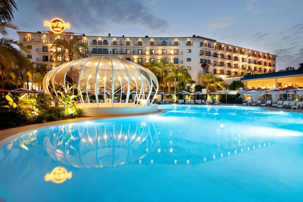 a large swimming pool with a blue sky at Hard Rock Hotel Marbella - Adults Only Recommended in Marbella
