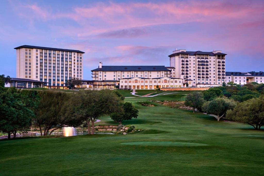 a view of a golf course with buildings in the background at Omni Barton Creek Resort and Spa Austin in Austin