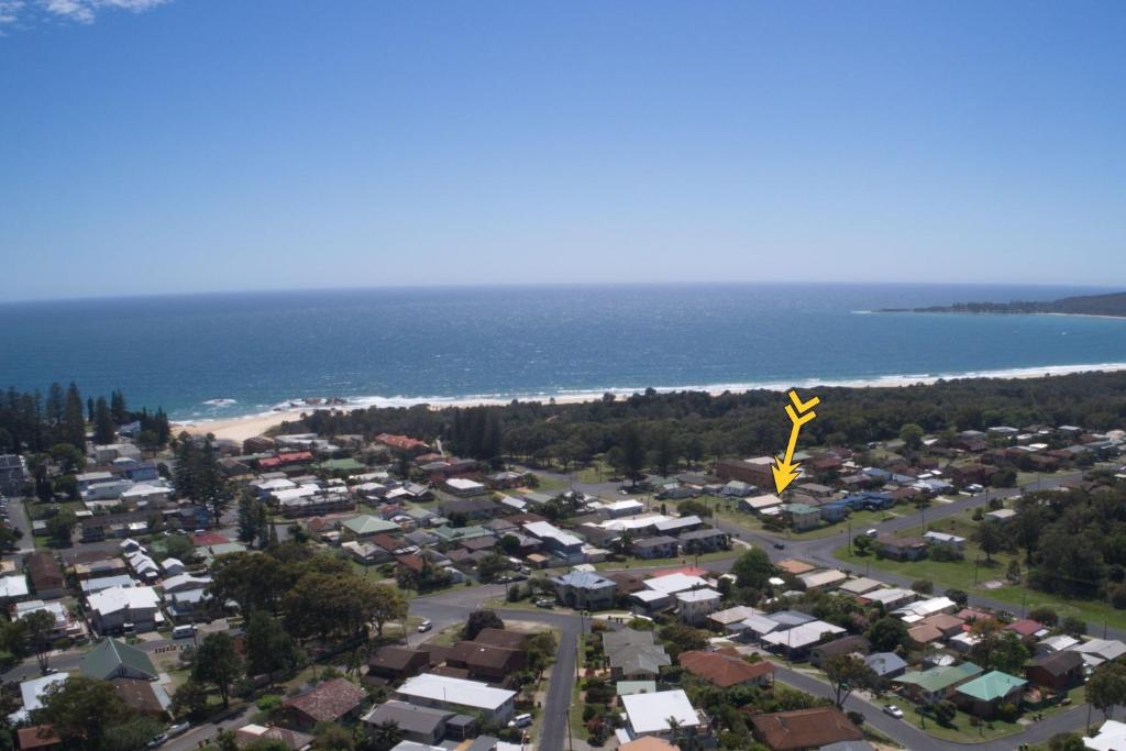 an aerial view of a town with houses and the ocean at Beach Retreat in South West Rocks