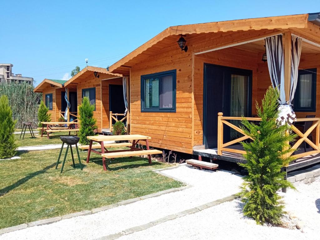 a log cabin with a picnic table in the yard at Sea garden apart in Demre