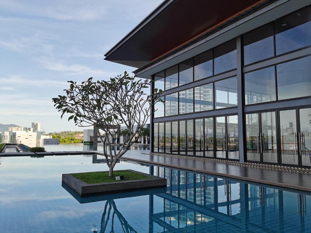 a building with a tree in the middle of a pool at Residensi Lili by James NEARBY KILA, KILA 2, PUTRAJAYA, CYBERJAYA in Nilai