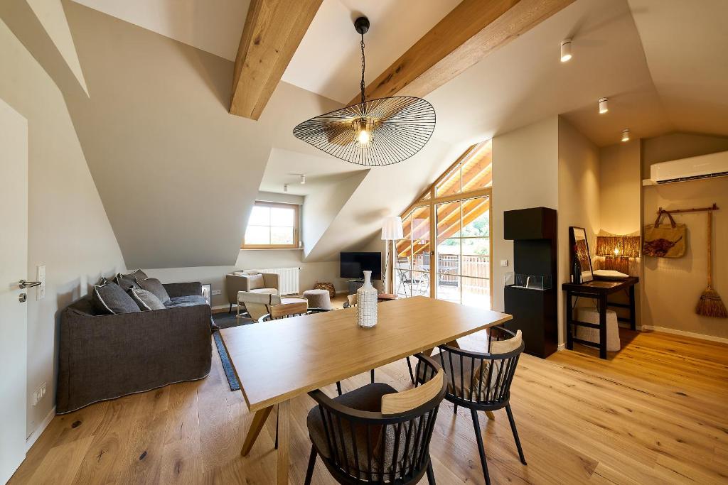 a dining room and living room with a table and chairs at Landhaus Wehlener Klosterberg in Bernkastel-Kues