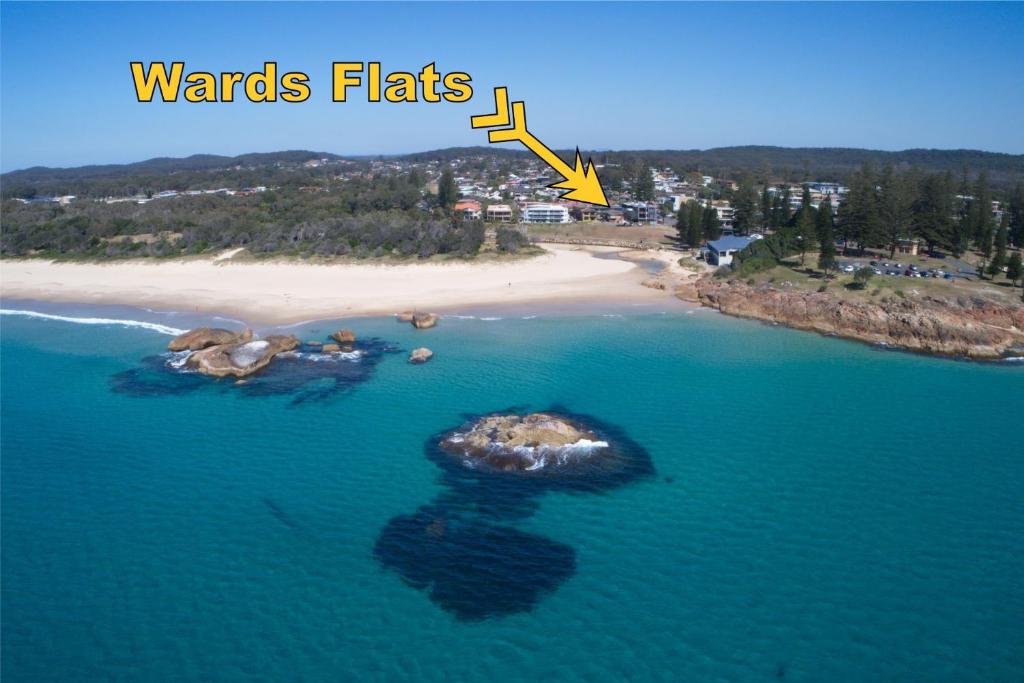 an island in the water next to a beach at Wards Holiday Flat 3 in South West Rocks