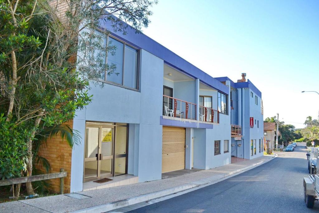a row of houses on the side of a street at Paragon Apartment 6 - Bring your own linen. in South West Rocks