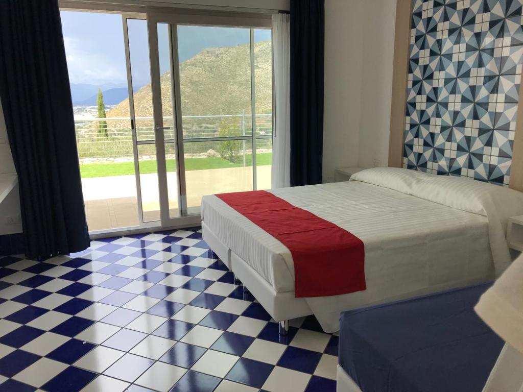 a bedroom with a bed and a checkered floor at Hotel Belvedere in Sperlonga