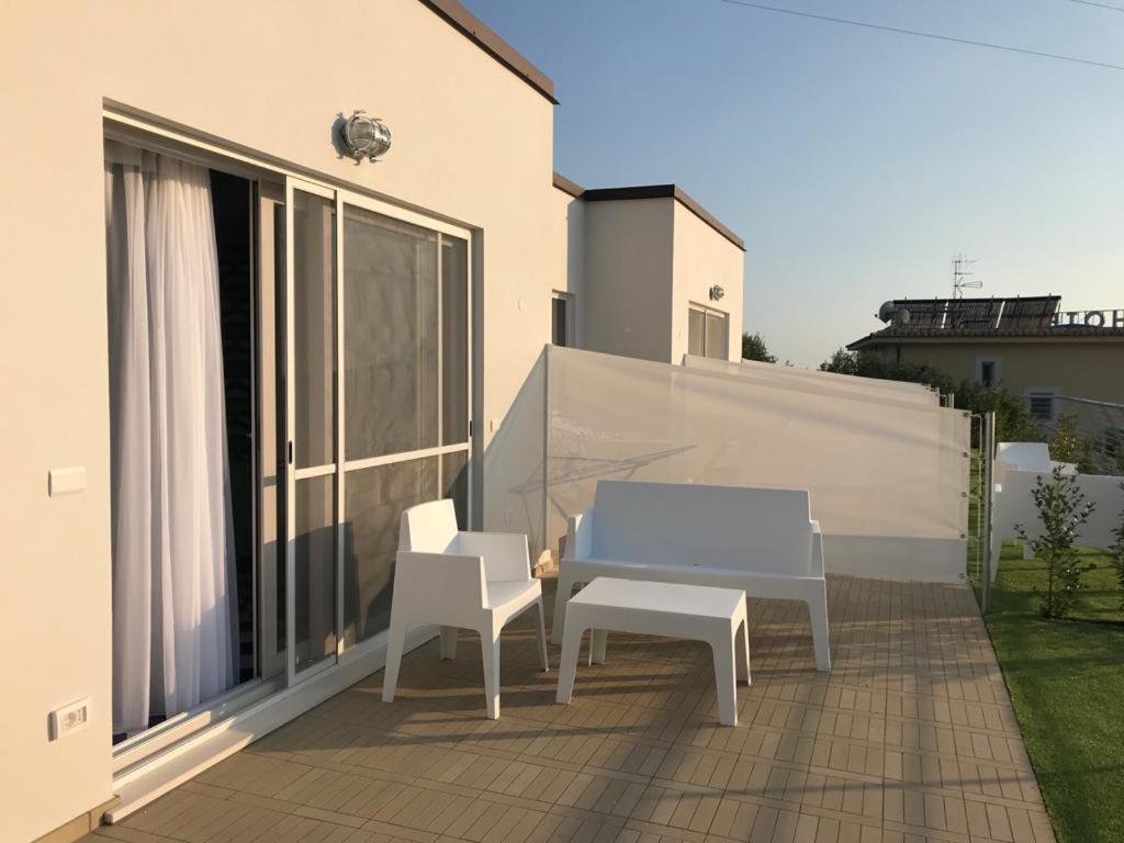 a patio with a blue table and two white chairs at Hotel Belvedere in Sperlonga