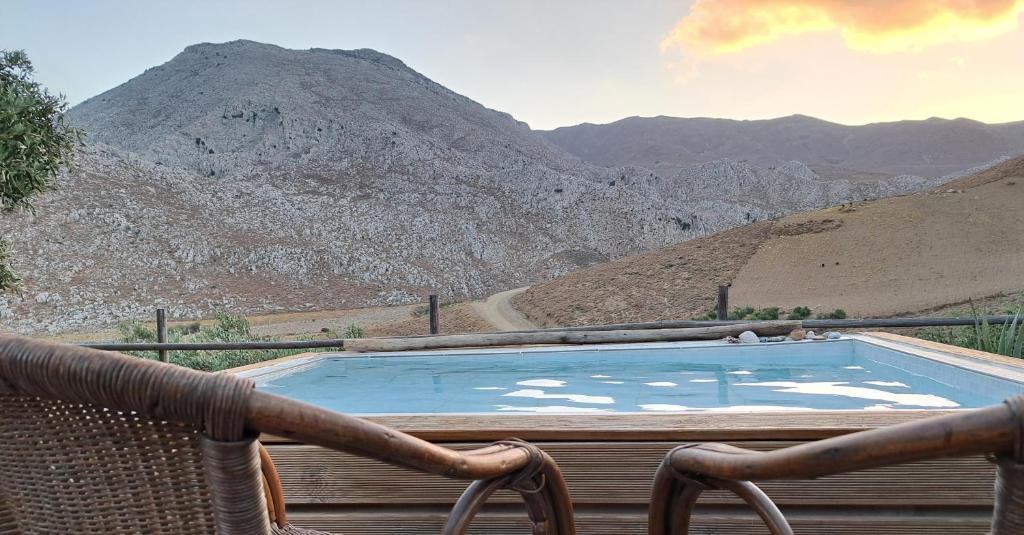 a swimming pool with a view of a mountain at Wooden House at the Mountain-private in Paránimfoi