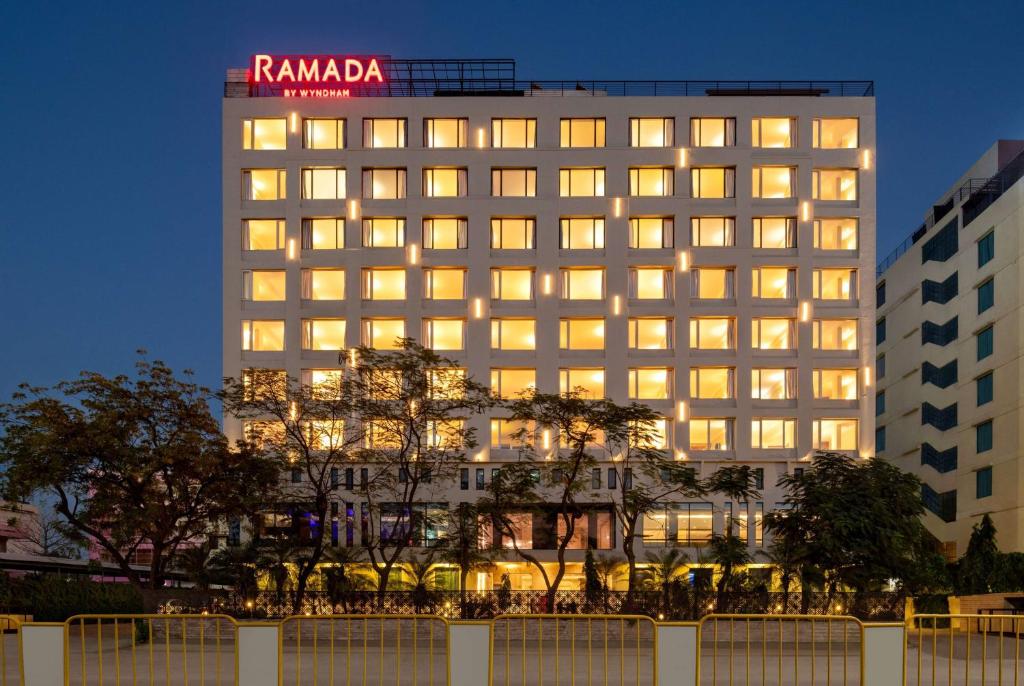 a building with a sign on top of it at Ramada by Wyndham Jaipur North in Jaipur