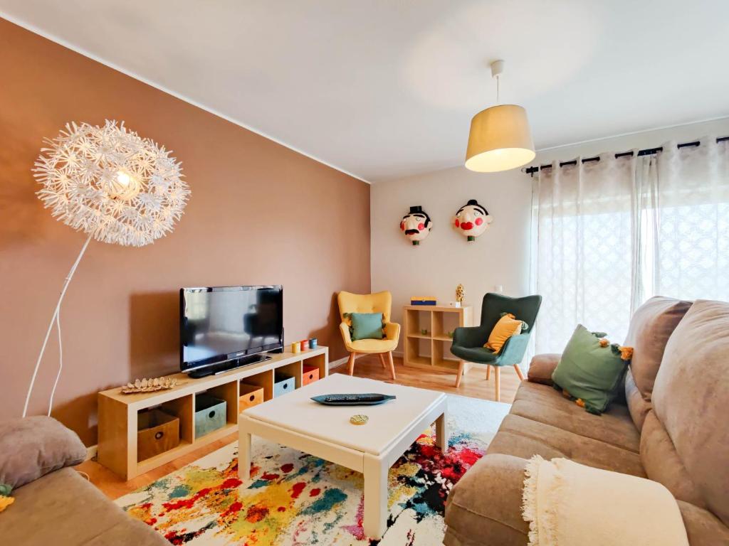 a living room with a couch and a tv at Da Silva House - Ap in Afife with Balcony & SeaView in Viana do Castelo
