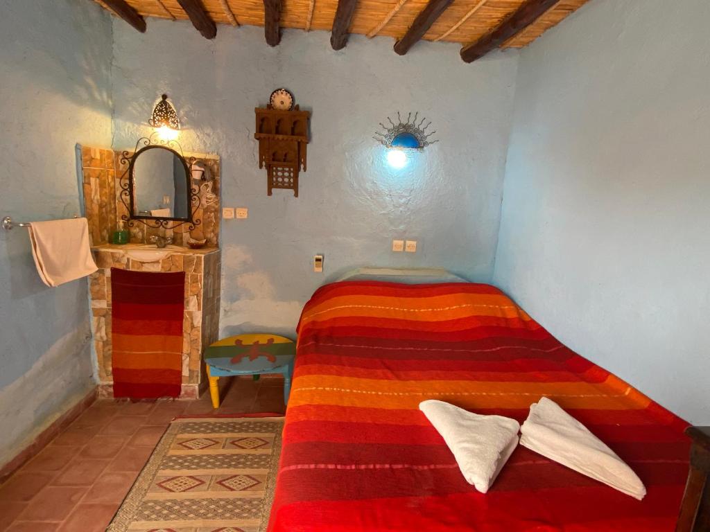 Postel nebo postele na pokoji v ubytování Auberge Kasbah Des Dunes