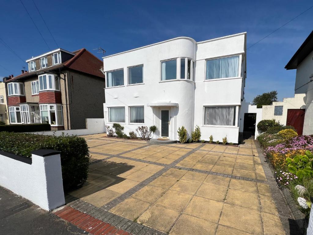 a white house with a courtyard in front of it at The Emberton in Bridlington