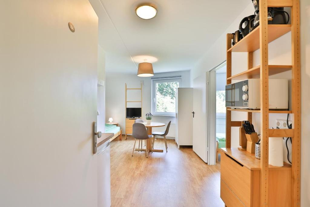 sala de estar y comedor con mesa y sillas en GROBO Apartments en Hamburgo