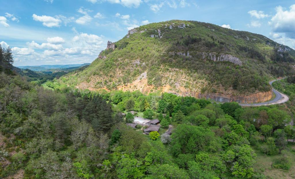 een luchtzicht op een berg met een kronkelende weg bij Village de Gîtes des Chalets du Camping du Golf in La Canourgue