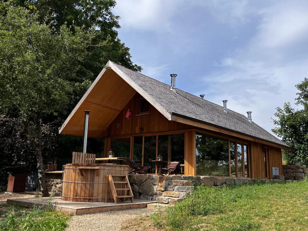 Enjoy Eco Lodge في Onhaye: منزل خشبي كبير مع نافذة كبيرة
