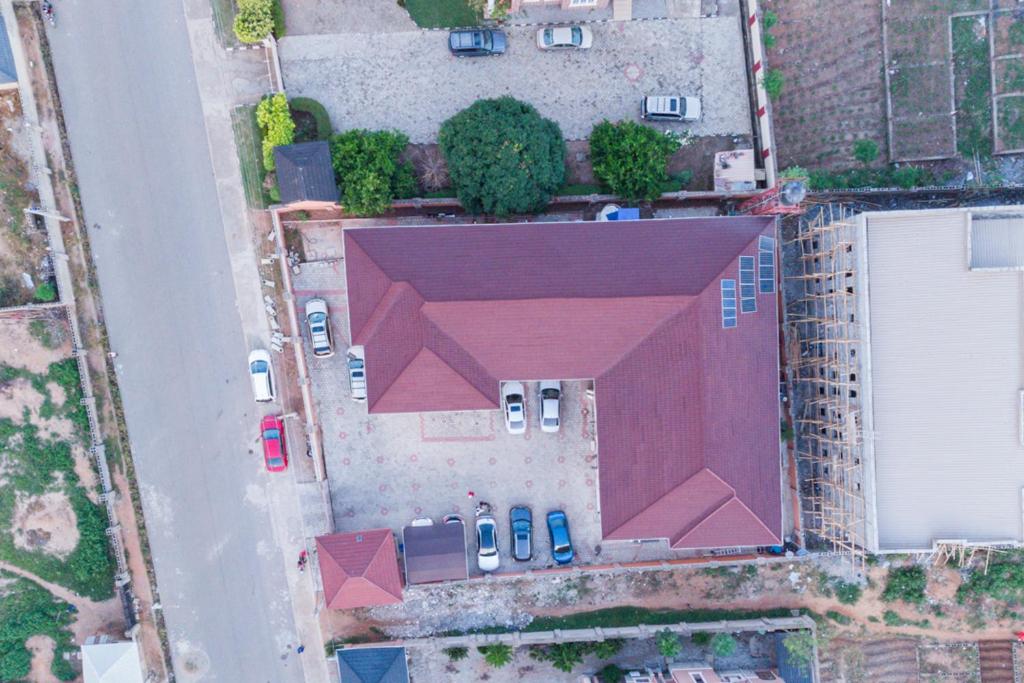 an overhead view of a building with cars parked at Plistbooking Xive 3 bedroom Luxury Abuja Apartment in Abuja