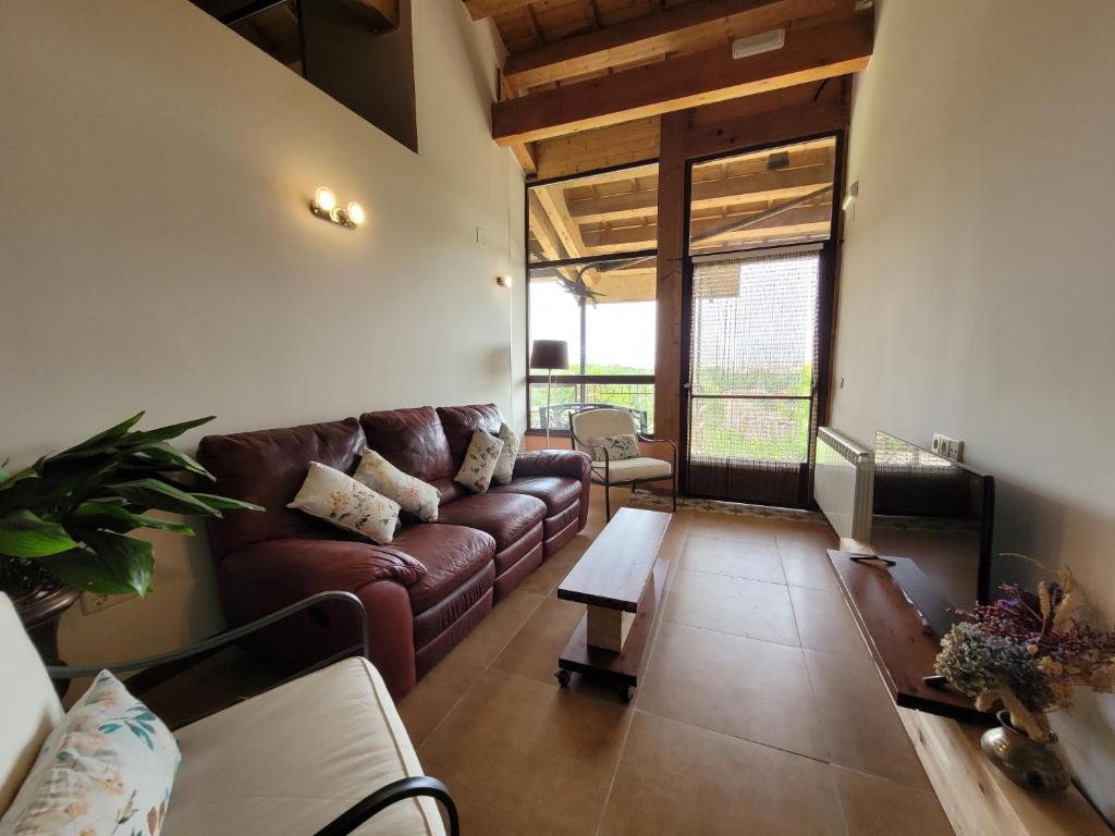 a living room with a couch and a table at El Mirador del Chispano in Ayllón