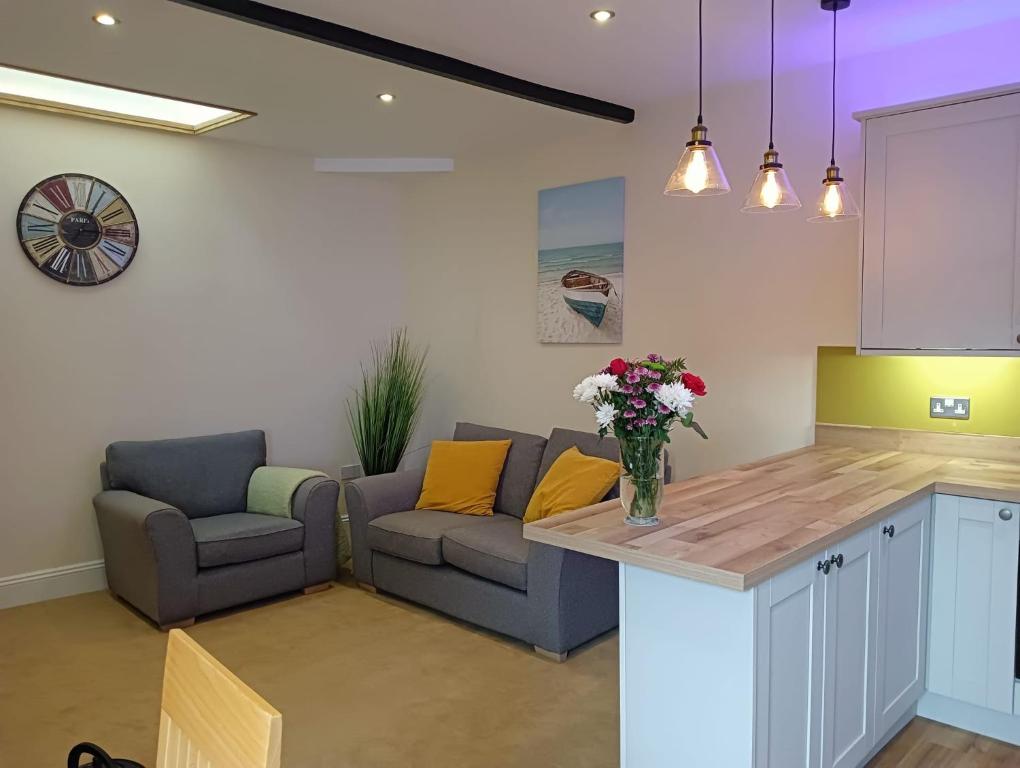 a kitchen and living room with a couch and a table at Catherine Street Apartments in Salisbury