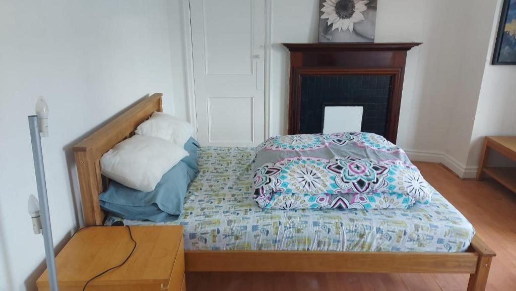 a bed in a room with a wooden table at London Edgware Station Apartment in London