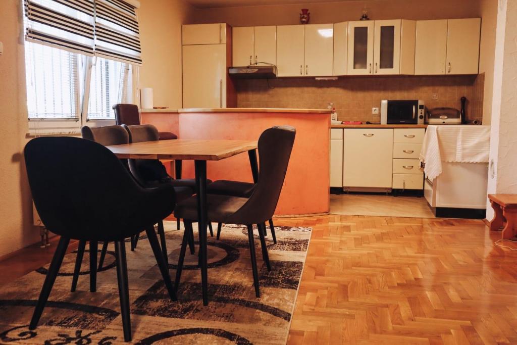 Una cocina con una mesa y sillas en una habitación. en Villa Sami, en Bihać