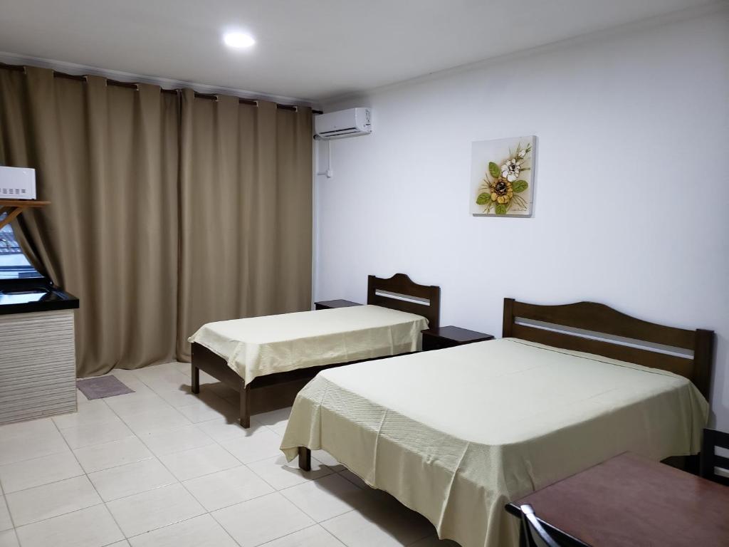 Ένα ή περισσότερα κρεβάτια σε δωμάτιο στο Estudio Recanto do Teimoso