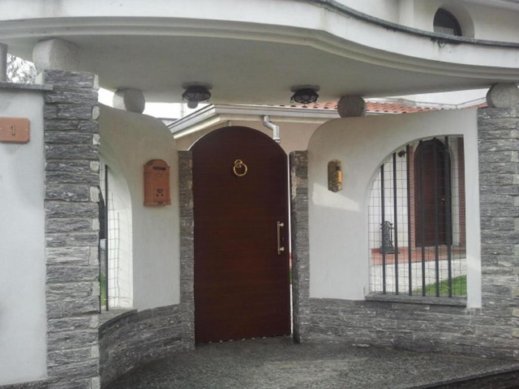 a entrance to a house with a brown door at Crespi House in Parabiago