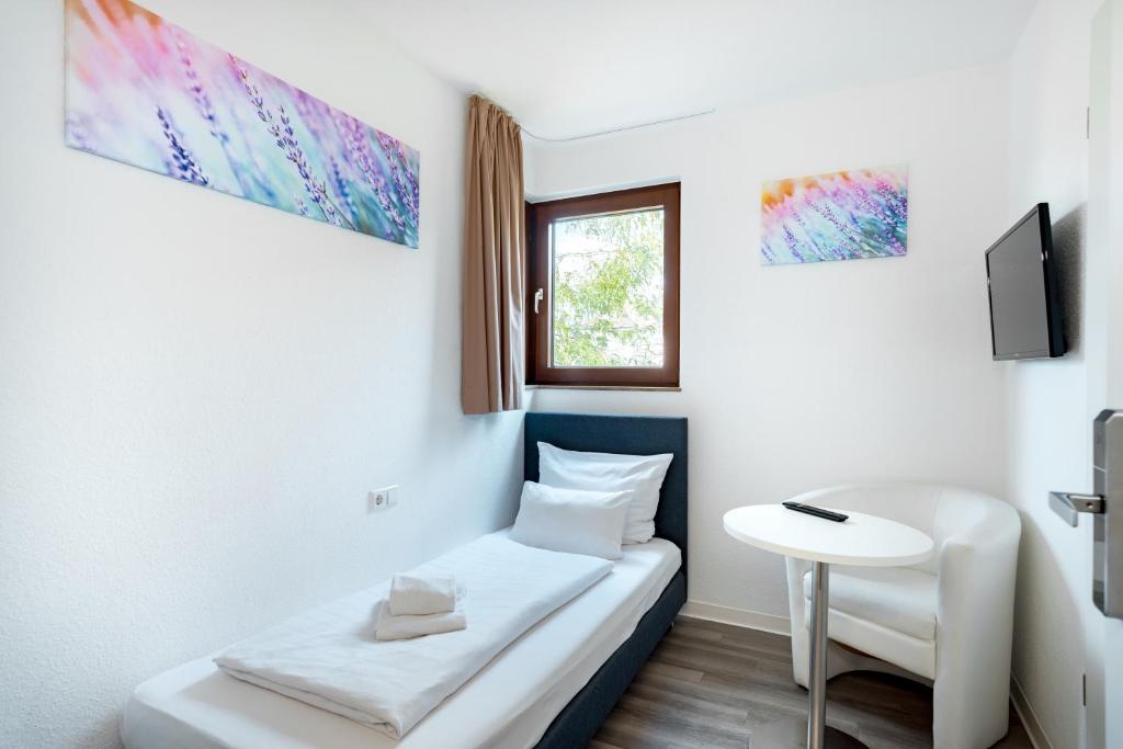 Postel nebo postele na pokoji v ubytování Hotel Garni am Olgaeck
