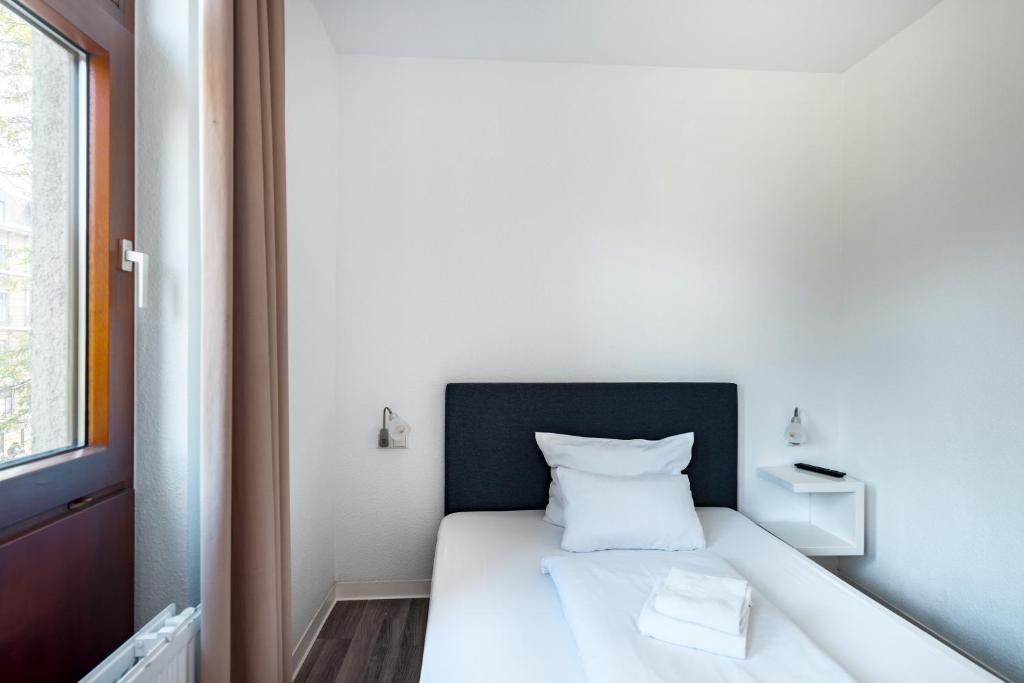 Postel nebo postele na pokoji v ubytování Hotel Garni am Olgaeck