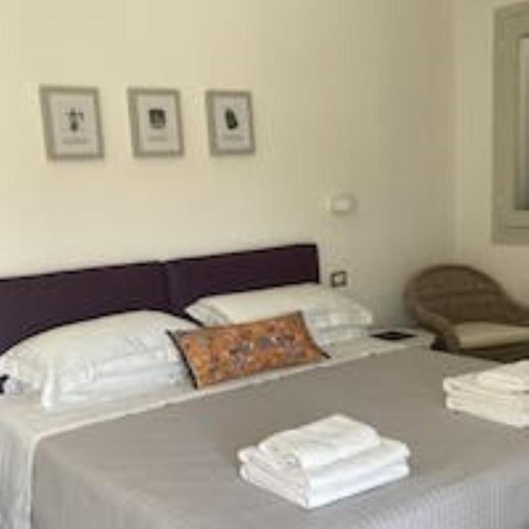 Een bed of bedden in een kamer bij Oliveto Bed and Breakfast