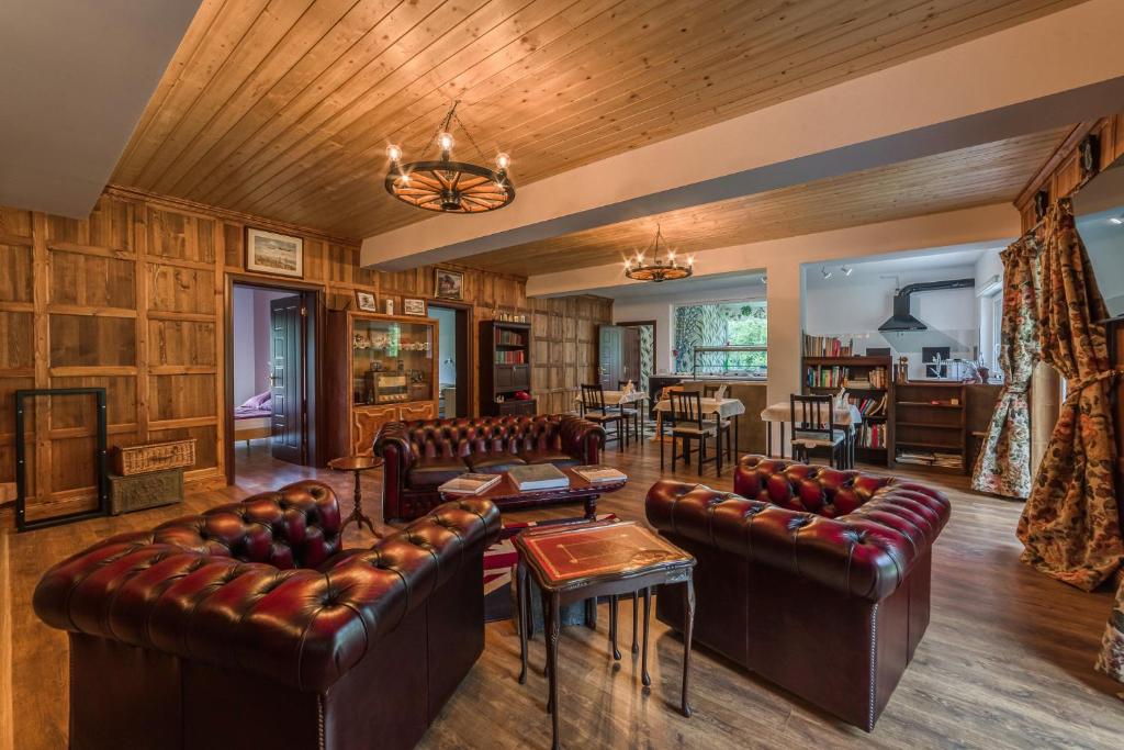a living room with leather furniture and a dining room at Mountain View Lodge in Ranintsi