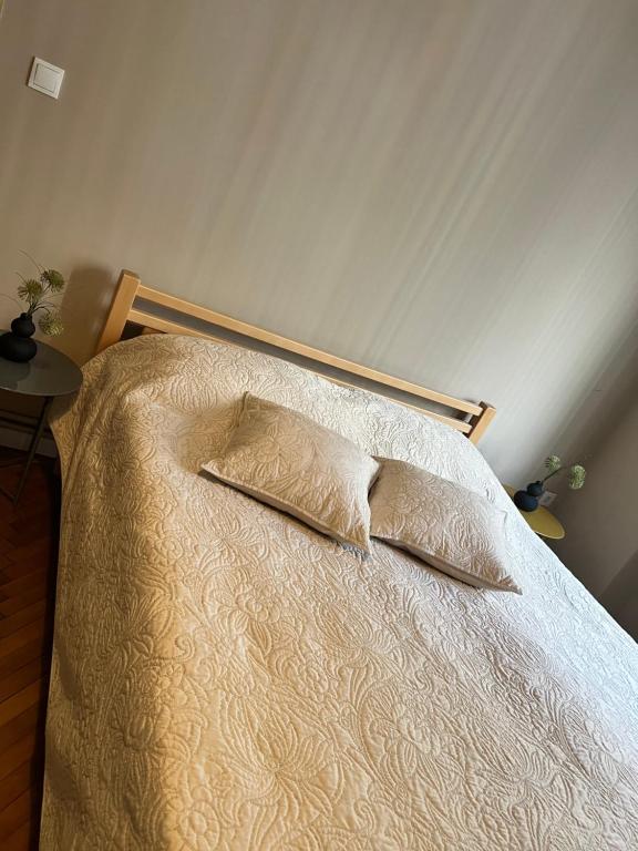 a bed with two pillows on it in a bedroom at Apartman Lulu 2 in Sarajevo