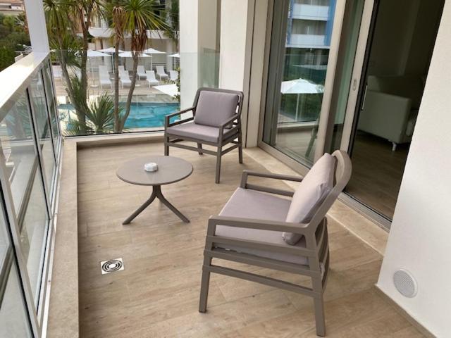 a patio with two chairs and a table on a balcony at YOUMAMI Suite Hotel Wellness&Spa in Giulianova