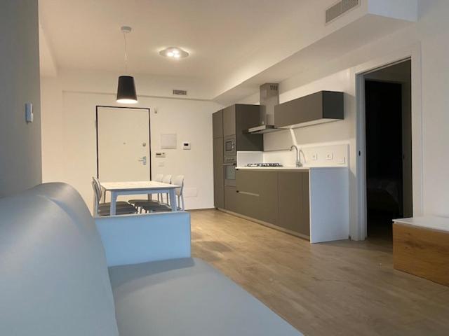 a kitchen with a table and a counter in a room at YOUMAMI Suite Hotel Wellness&Spa in Giulianova