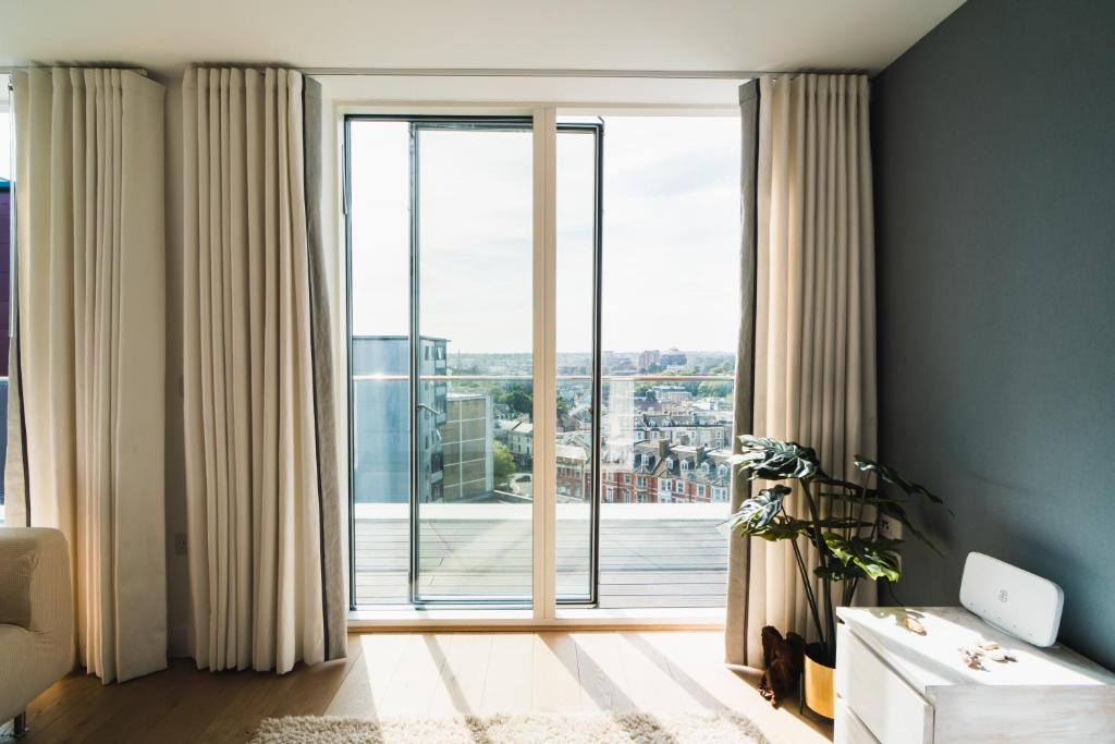 a living room with a large window with a view at Penthouse at the Chocolate Box in Bournemouth