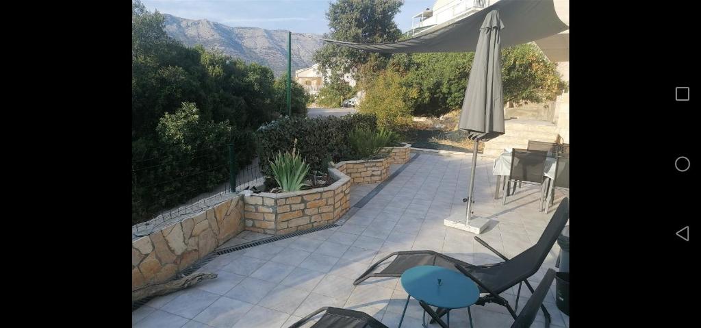 a patio with an umbrella and a table and chairs at Villa Giulia in Korčula