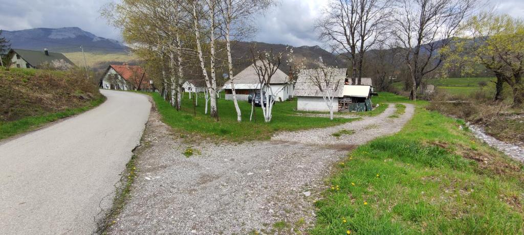an empty road next to a house on a hill at House Vidakovic in Kolašin