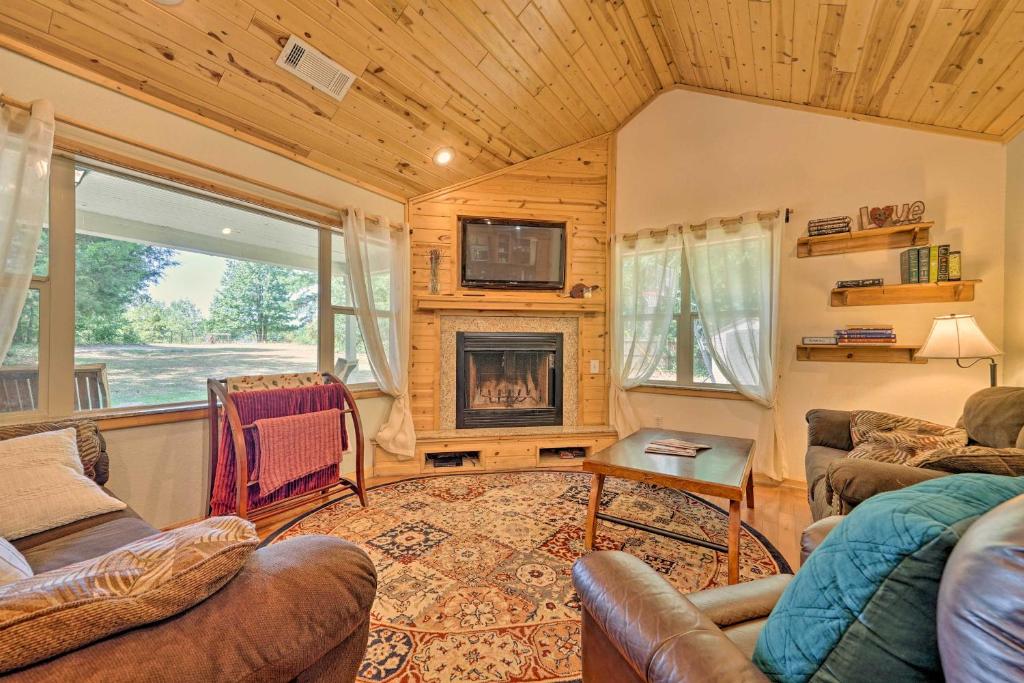 a living room with a couch and a fireplace at Smithville Remote Escape with Furnished Deck! in Smithville