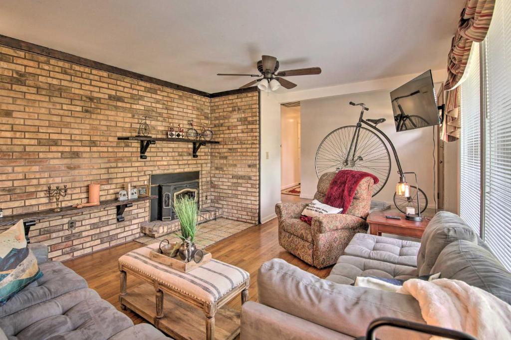 a living room with two couches and a brick wall at Bright Springfield Home Walk to Nature Center! in Springfield